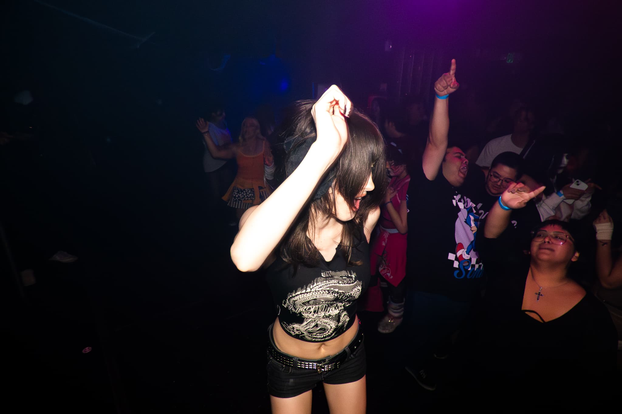Event photography by Chase Tipton - Photo of a dancer elevated above the crowd, surrounded by people cheering and enjoying the moment
